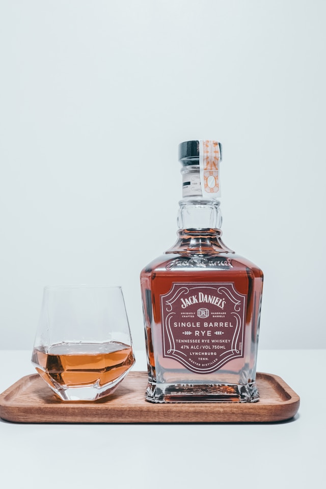 A bottle of Jack Daniel's single barrel rye whiskey next to a glass.