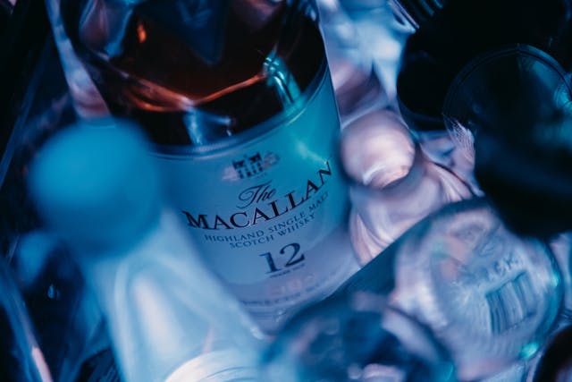 A close-up of The Macallan whisky surrounded by glass bottles.