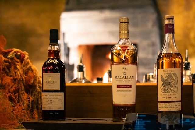 Three whiskey bottles displayed: A.D. Rattray 15, Macallan Classic Cut, and Marolo Grappa di Barolo 1994.